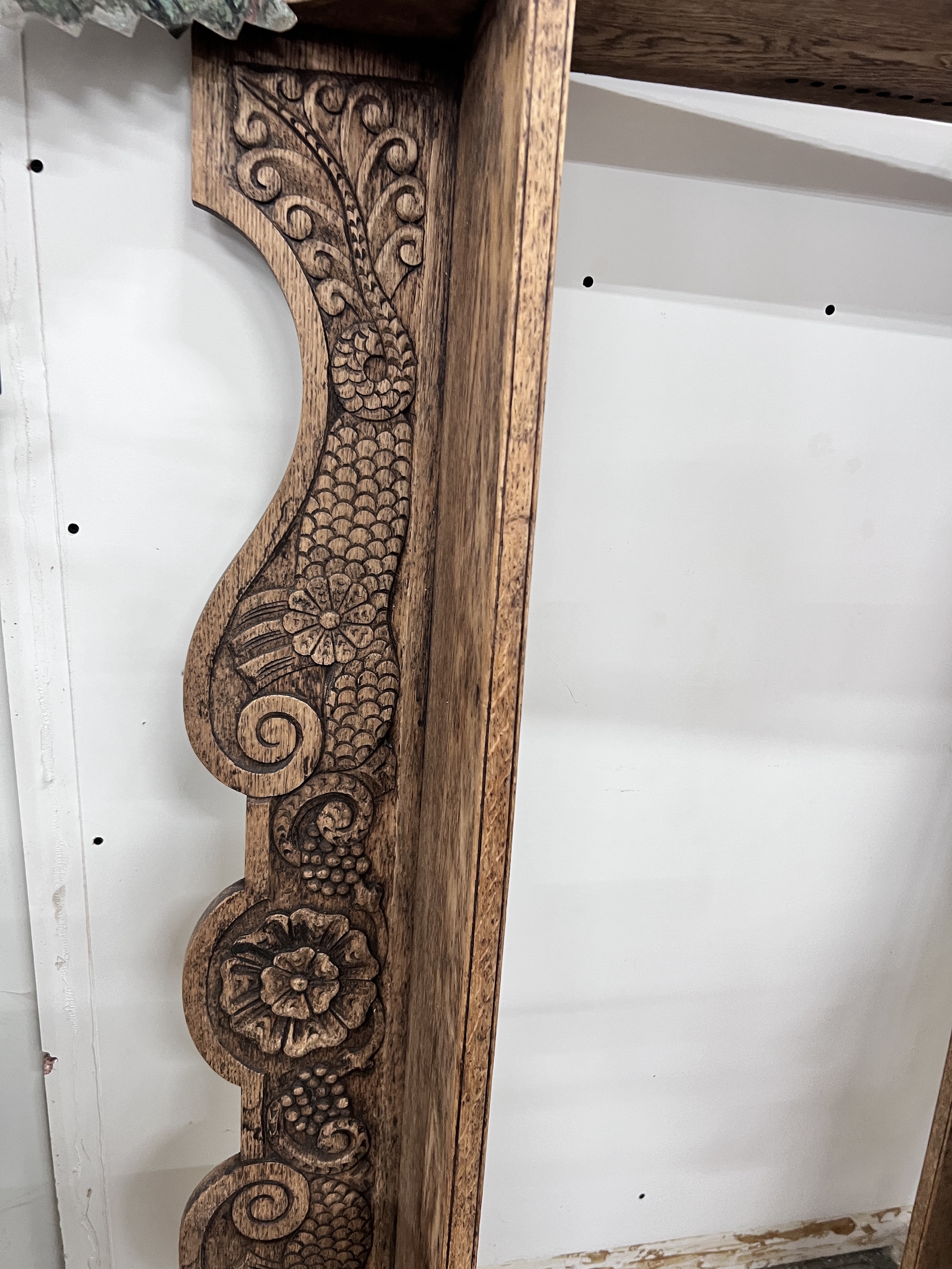 An early 20th century carved oak wall bracket, width 144cm, depth 22cm, height 99cm